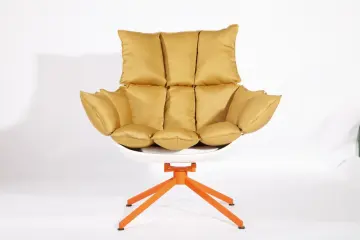 white husk chair with orange seat cushion