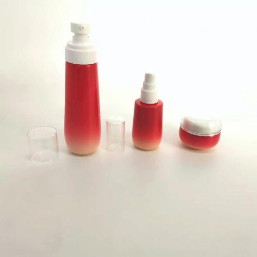 Conjunto de botella de vidrio cosmético degradado rojo
