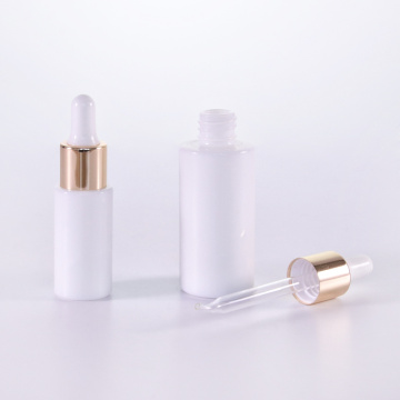 Cylinder white glass serum bottle with golden dropper