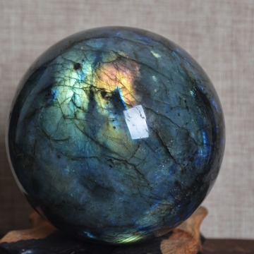 Natural Labradorite crystal ball, with different light, the surface will produce different brilliant colors.