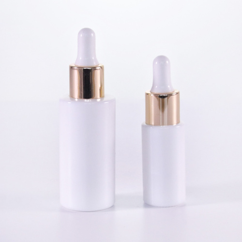 Cylinder white glass serum bottle with golden dropper