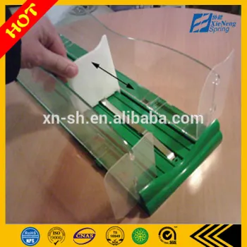 variable force spring for shelf pusher