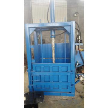 Waste paperboard baler machine