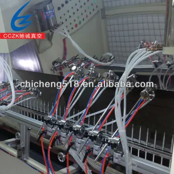 Automatic UV spray line for perfume caps