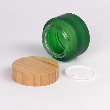Frosted green cosmetic glass jar with bamboo lid