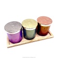 Christmas style colored glass candle jar with embossed metal lid