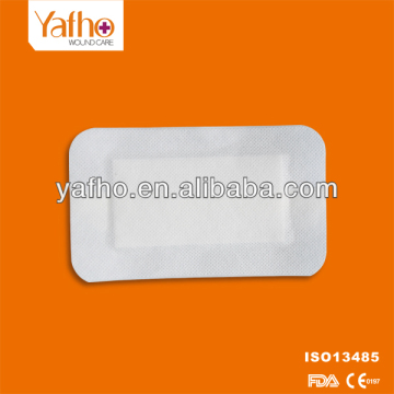 Non-woven self adhesive wound dressings