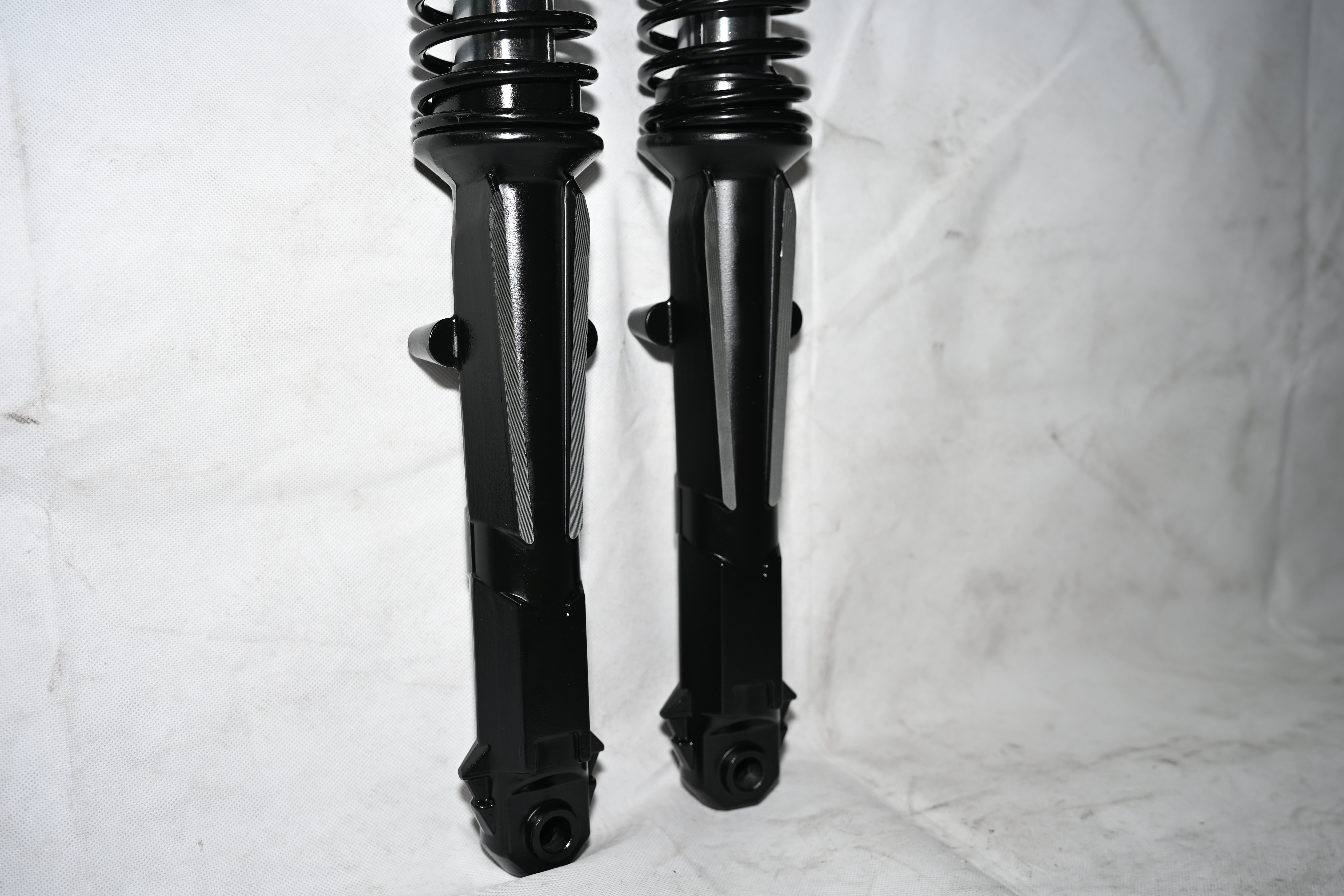 External spring tip shock absorber