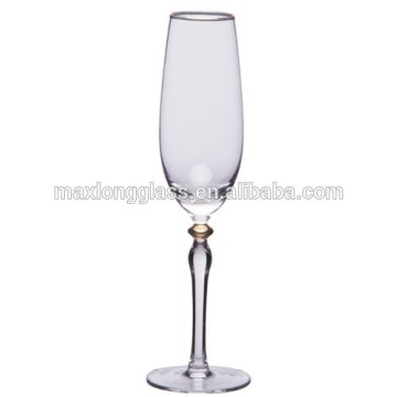 Clear champagne glass with gold painting on stem
