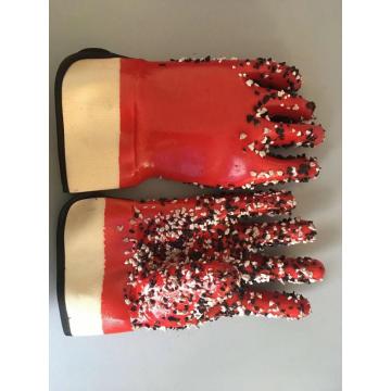 Red pvc gloves with chips on the palm