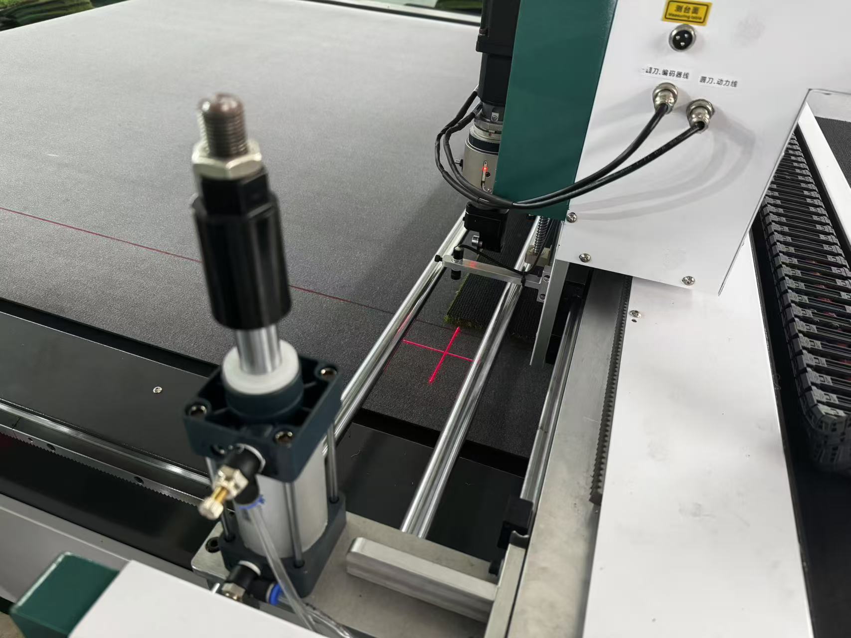 Laser positioning for digital turf cutting machine