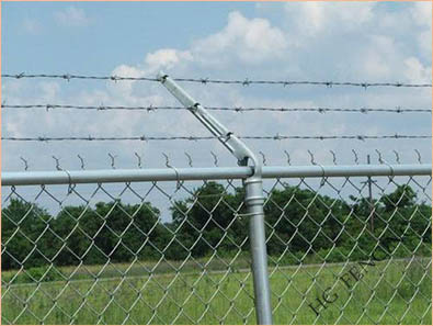 Barbed wire mounted on top of chain link fence