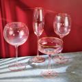 pink colored wine glass set with gold rim