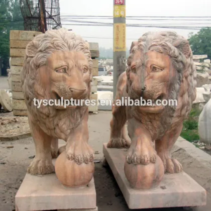 The lion statues standing on the ball