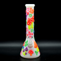 A glass water pipe with a colorful mushroom pattern