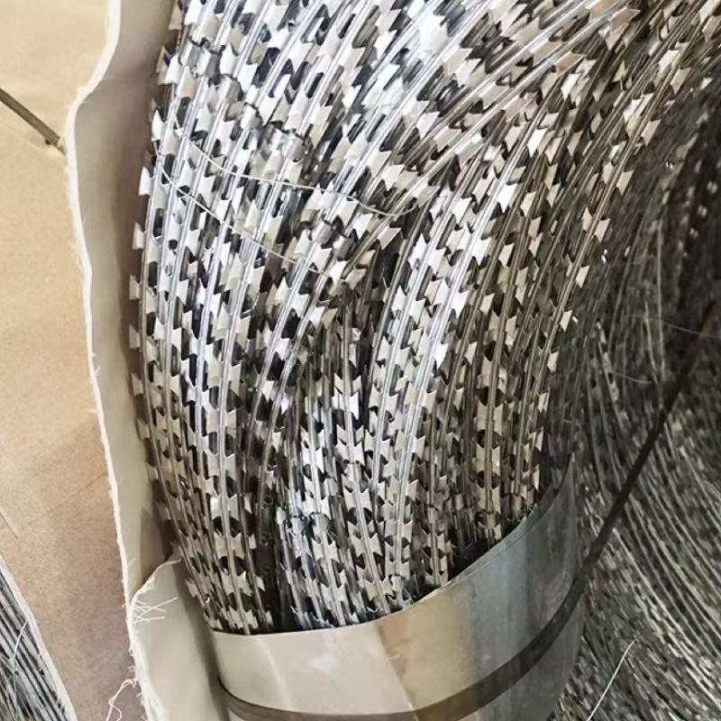 ANJIA Group bulk stacked galvanized CBT-60 razor wire concertina rolls factory stock for security projects