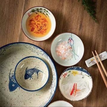 Classic Asian Bowls and Plates with Fish and Flower Motifs