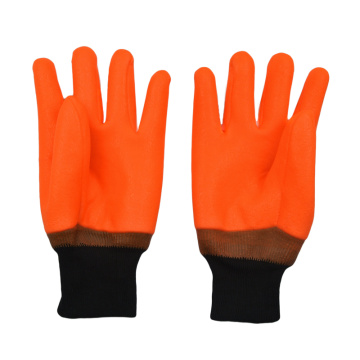 Fluoreszierende orange PVC-beschichtete Handschuhe sandig