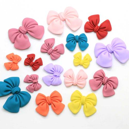 100 sztuk kolorowe Bowknot żywica rzemiosło dekoracyjne muszka wstążka Flatback Cabochon księga gości DIY ozdoby akcesoria