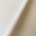 Tejido de poliéster cepillado de terciopelo blanco de punto de urdimbre para tapicería
