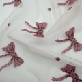 Maglia in tulle di poliestere glitterato con punti di fiocco