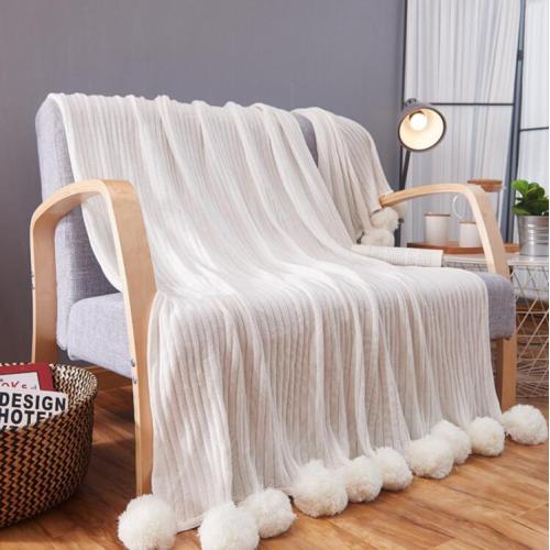 Knitted wool blanket with POMPOMS