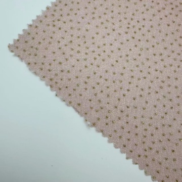 Gestrickter Jerseystoff mit goldenen Glitzerpunkten