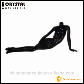 Female art young models lying black headless mannequin