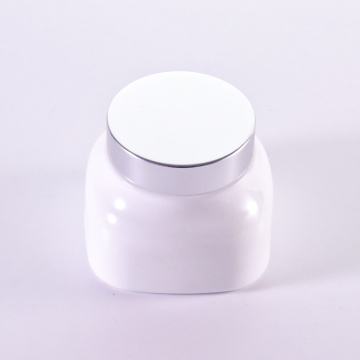 Square white glass cream jar with silver cap