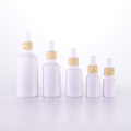 white essential oil bottle with bamboo texture dropper