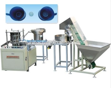 Non spill cap plug stopper assembly insert machine