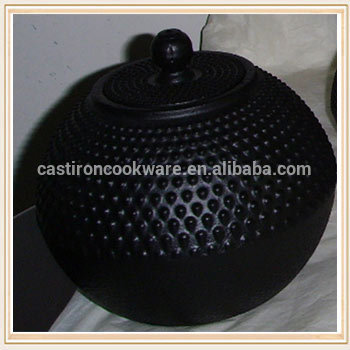 black round vegetable oil cast iron tea warmer