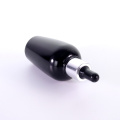 Black glass bottle with silver dropper cap