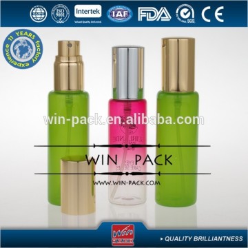 green essential oil bottle with shiny gold aluminum cap and sprayer