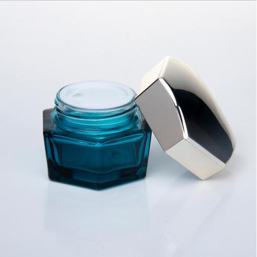 Blauwglazen hexagon cosmetische containers met zilveren dop