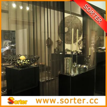 Sorter's curtain wall metal coil drapery