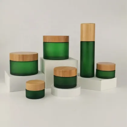 Frosted green cosmetic glass jar with bamboo lid