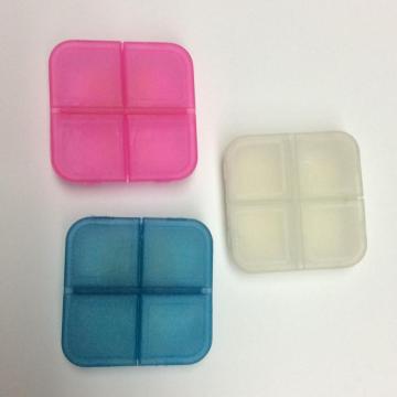 Mini caja de pastillas de plástico de cuatro rejillas portátil