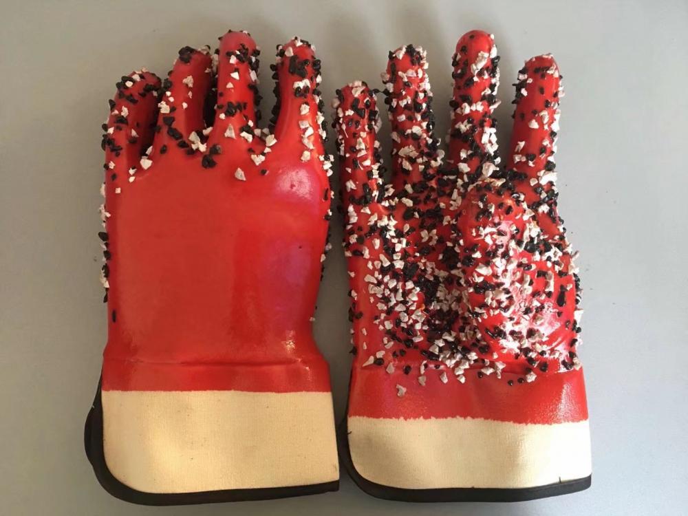 Red pvc gloves with chips on the palm