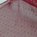 Tessuto in tulle increspato con stampa laminata a pois dorati