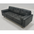 Light colored leather three person sofa