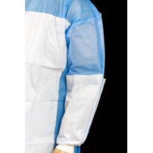 Disposable sugical gown material with reinforced piece