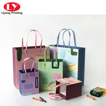 Clothing gift shopping paper bags with ribbon