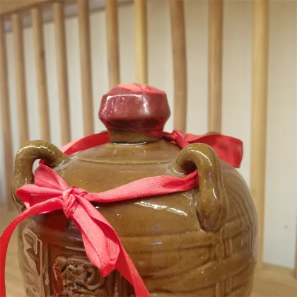 Yellow porcelain jar filled with yellow wine