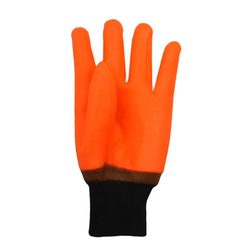 Fluoreszierende orange PVC-beschichtete Handschuhe sandig