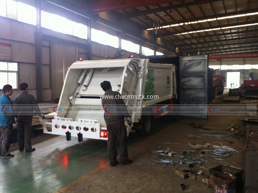 waste compactor truck load into container