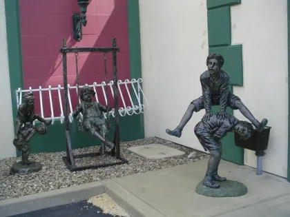 bronze two kids playing leapfrog statue for sale