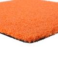 Rumput rumput sintetis oranye