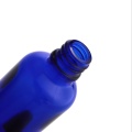 Botellas redondas de vidrio azul de 1 oz con goteros negros