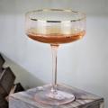 hand blown champagne saucer glass with gold rim